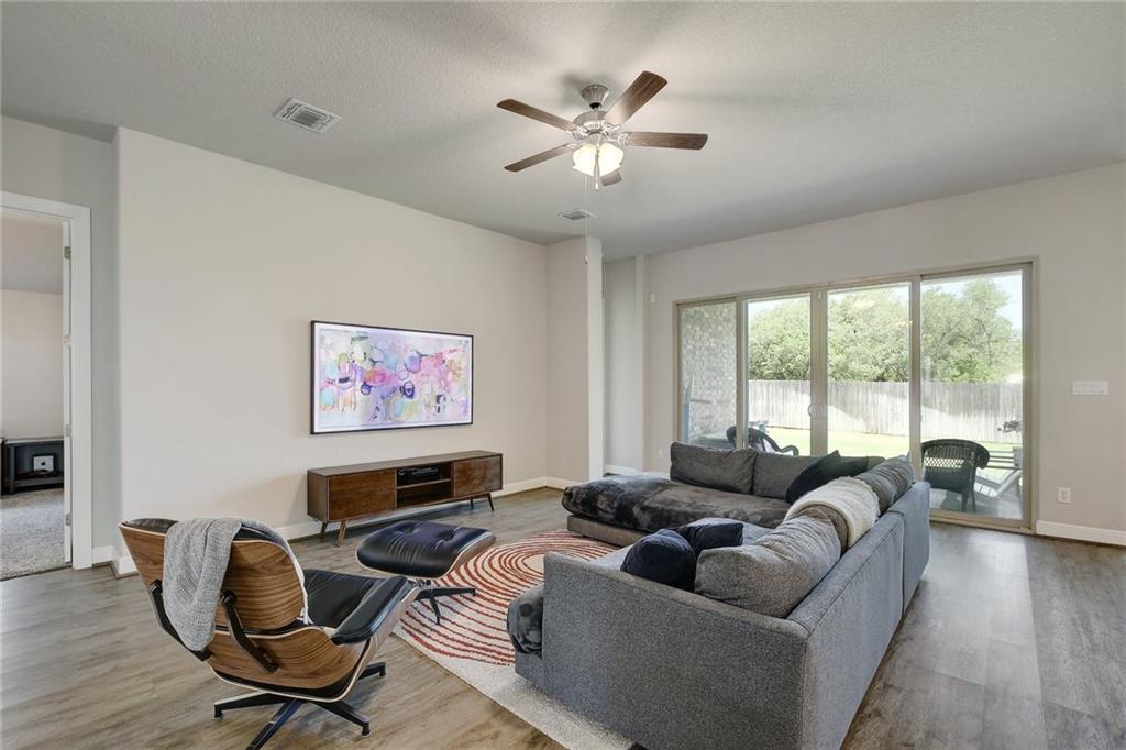 416 Peakside Circle Dripping Springs, TX 78620 - Photo 5 of 31 a living room with furniture ceiling fan and a window