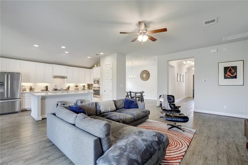 416 Peakside Circle Dripping Springs, TX 78620 - Photo 7 of 31 a living room with furniture and kitchen view