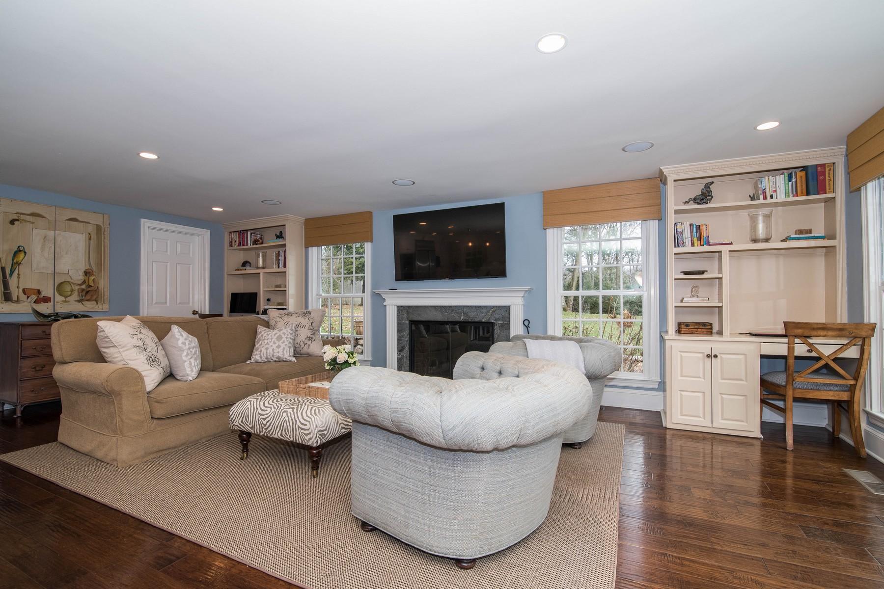 142 Brookside Road Darien, CT 06820 - Photo 12 of 25 a living room with furniture a fireplace and a flat screen tv