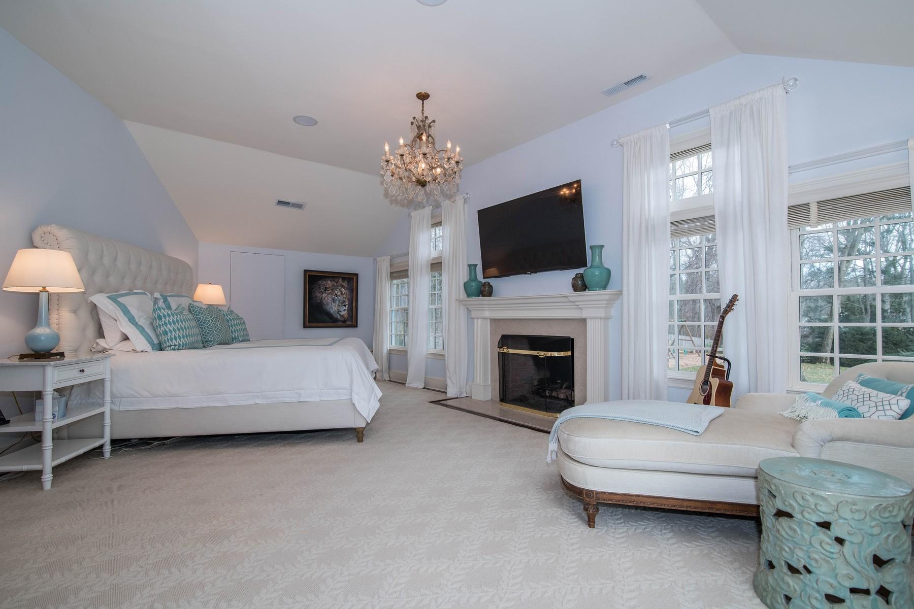 142 Brookside Road Darien, CT 06820 - Photo 14 of 25 a living room with furniture a fireplace and a flat screen tv