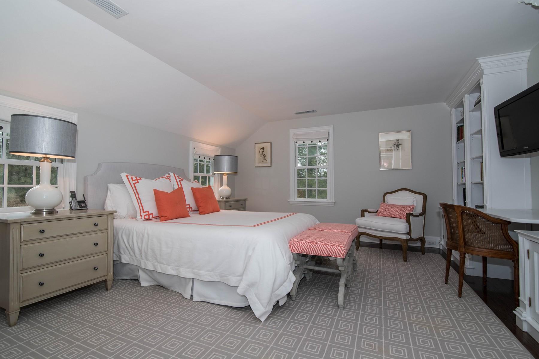 142 Brookside Road Darien, CT 06820 - Photo 16 of 25 a bedroom with a bed and flat tv screen on the dresser