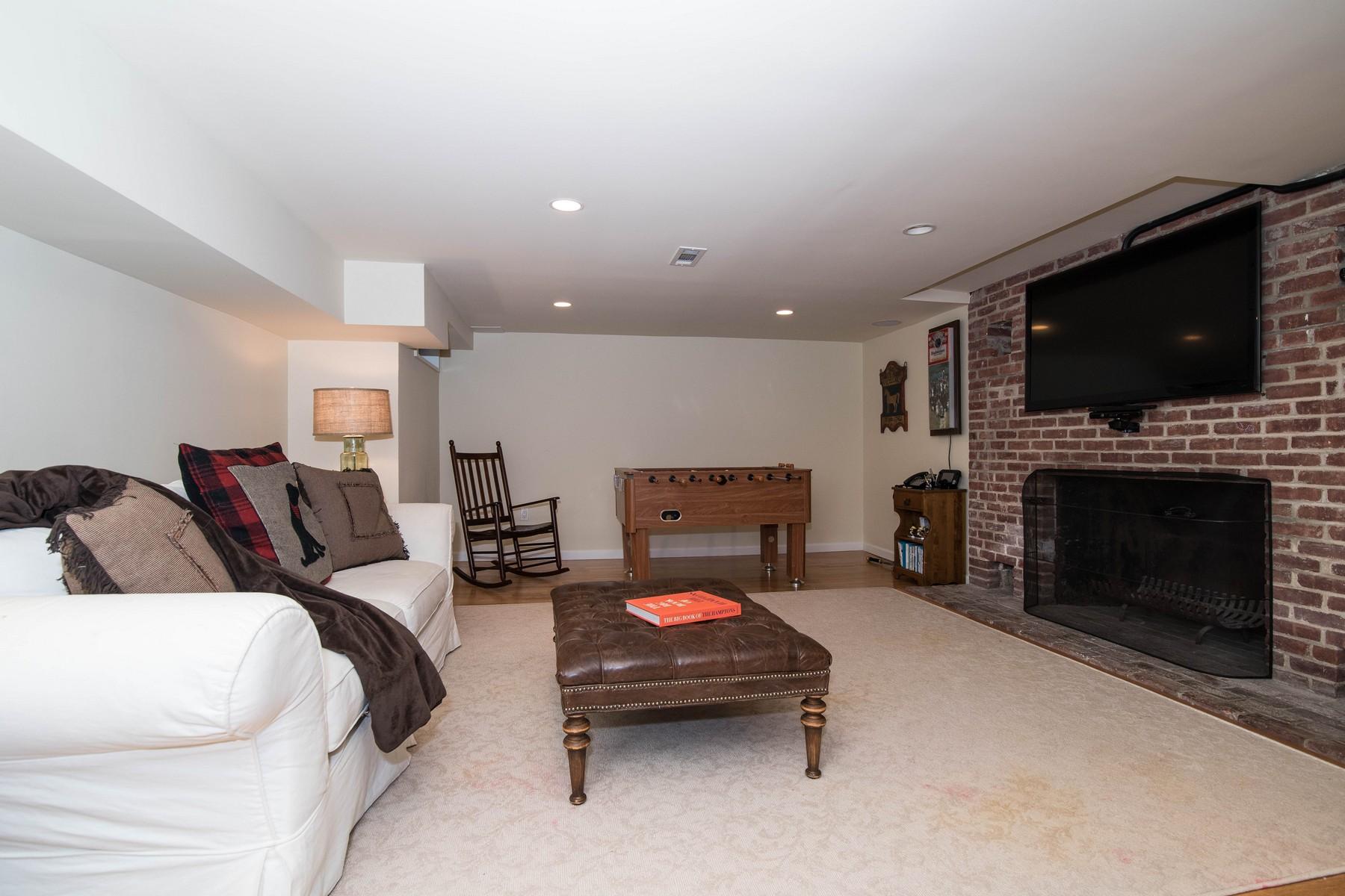 142 Brookside Road Darien, CT 06820 - Photo 21 of 25 a living room with furniture a flat screen tv and a fireplace