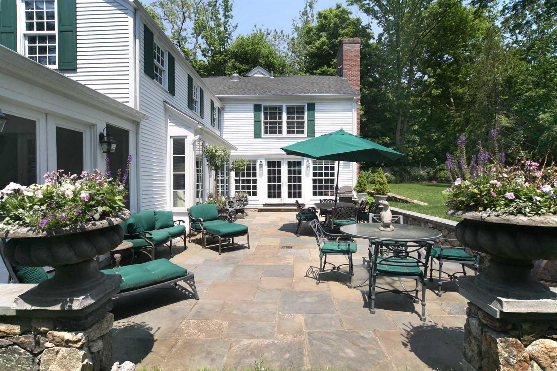 142 Brookside Road Darien, CT 06820 - Photo 24 of 25 a view of a patio with couches table and chairs potted plants and large tree