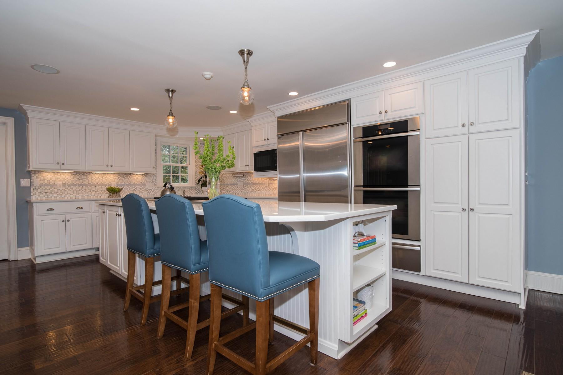 142 Brookside Road Darien, CT 06820 - Photo 9 of 25 a kitchen with a table chairs refrigerator and microwave