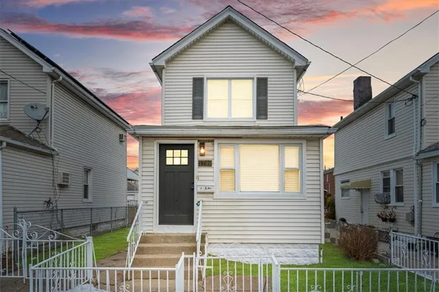 a view of a house with iron fence