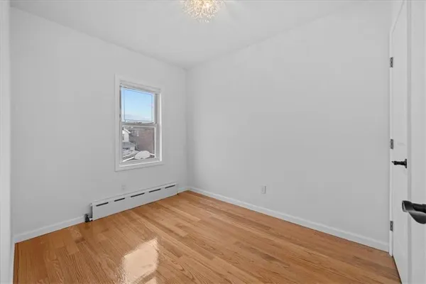 a view of a room with wooden floor and windows