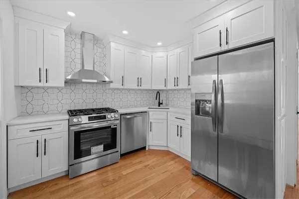 a kitchen with stainless steel appliances granite countertop a stove a refrigerator and a granite counter tops