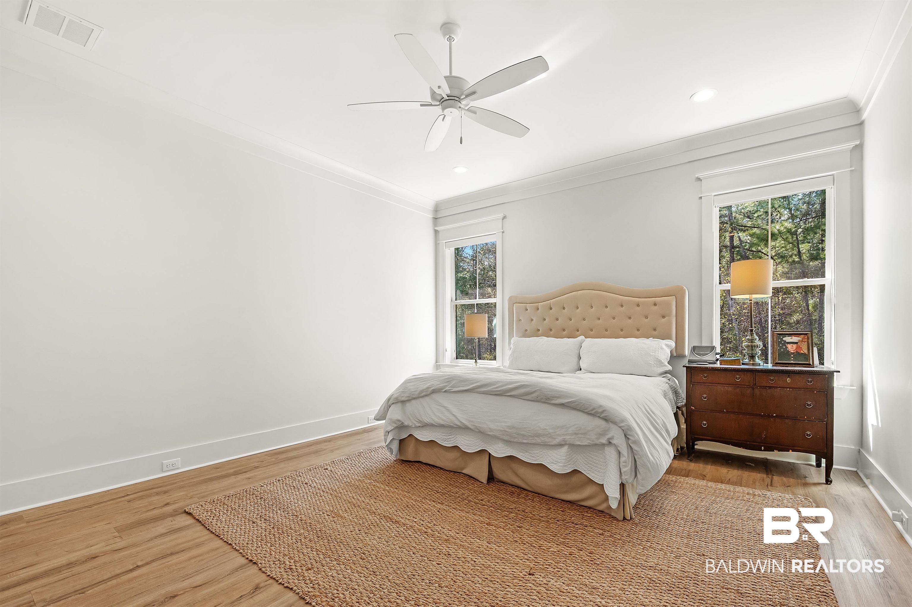 27888 Oakachoy Loop Daphne, AL 36526 - Photo 21 of 65 Bedroom with baseboards, visible vents, light wood-type flooring, and ornamental molding