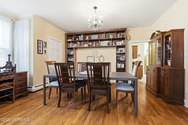 a view of a dining room with furniture and wooden floor