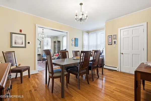 a view of a a dining room with furniture window and wooden floor