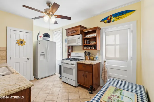 a kitchen with stainless steel appliances granite countertop a stove and a refrigerator