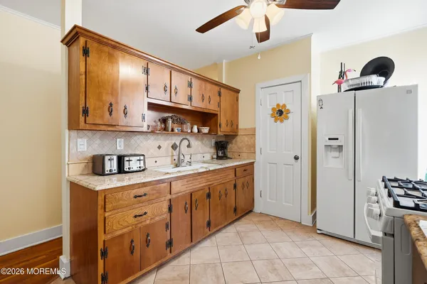 a kitchen with stainless steel appliances granite countertop a refrigerator and a sink
