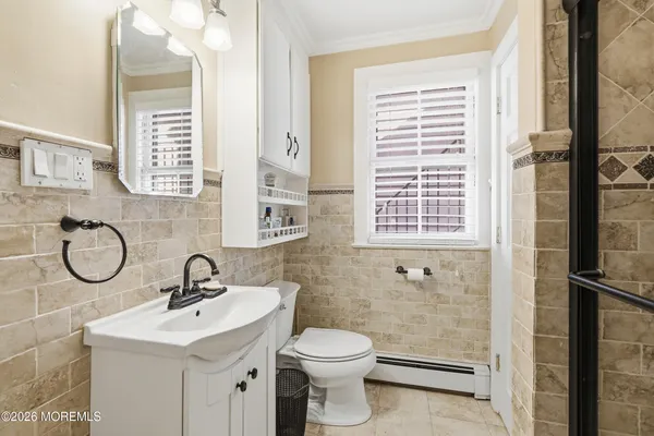 a bathroom with a toilet sink and a mirror