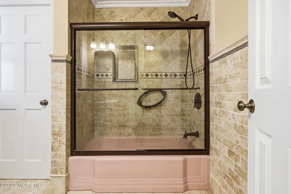 a bathroom with a glass shower door