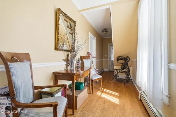 a view of a hallway with furniture and windows