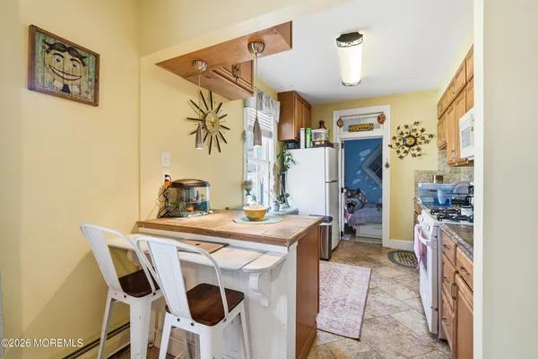 a view of a dining room with furniture and a chandelier