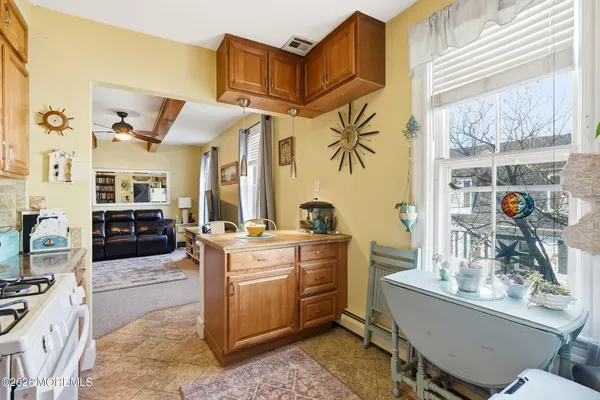 a kitchen with cabinets a counter and chairs