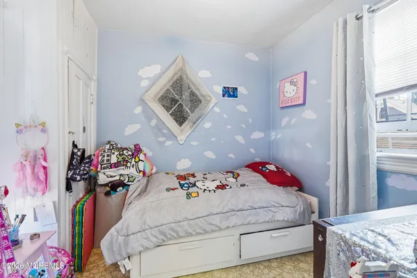 a bedroom with a bed and a dresser