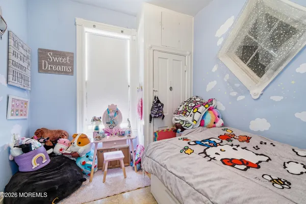 a bedroom with baby toys and a couch