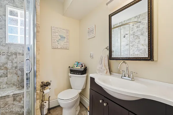 a bathroom with a toilet a sink and a mirror