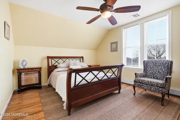 a bed sitting in a bedroom next to a window