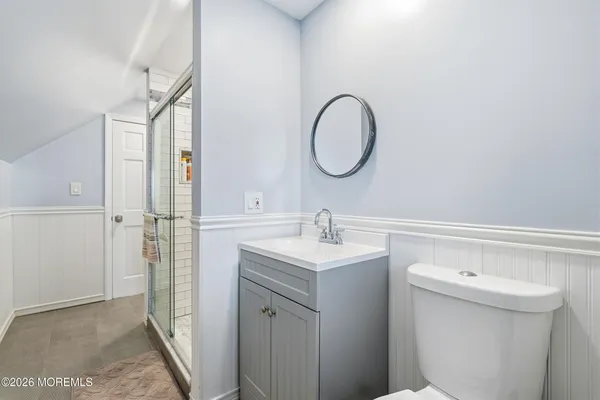 a bathroom with a sink a toilet and a mirror