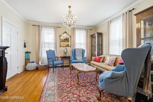 a living room with furniture and a chandelier