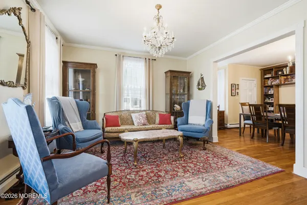 a living room with furniture and a chandelier