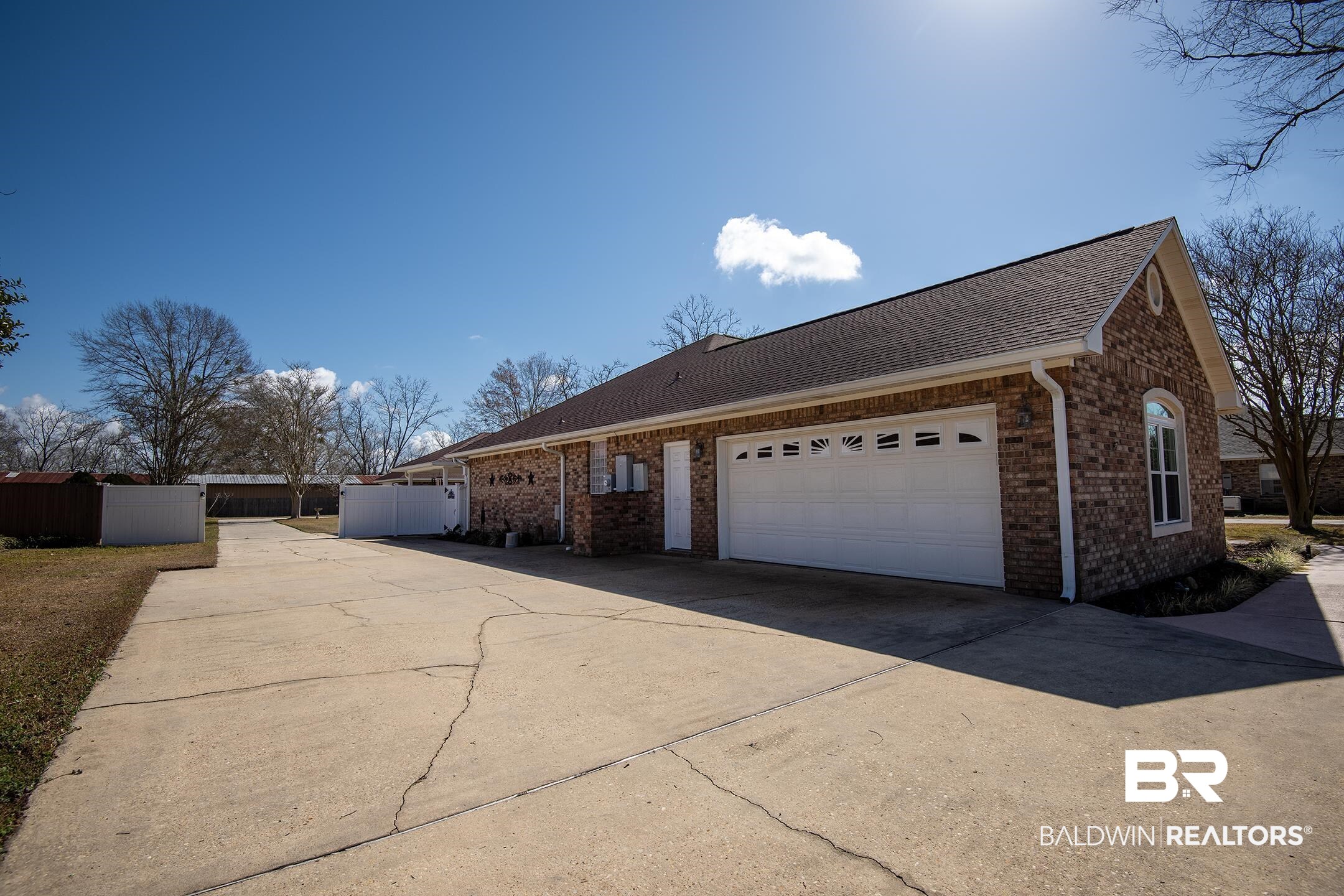 12626 Hunters Chase Foley, AL 36535 - Photo 32 of 40 View of side of property featuring concrete driveway, a shingled roof, brick siding, and a garage