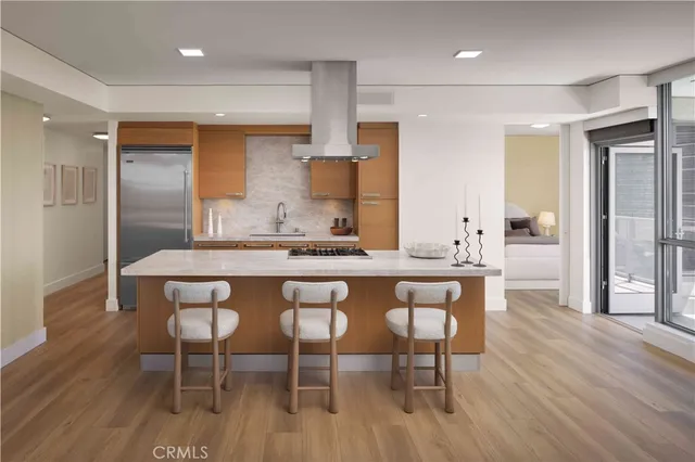 a dining hall with stainless steel appliances kitchen island wooden floor and view living room