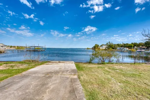 a view of a lake with houses in the back