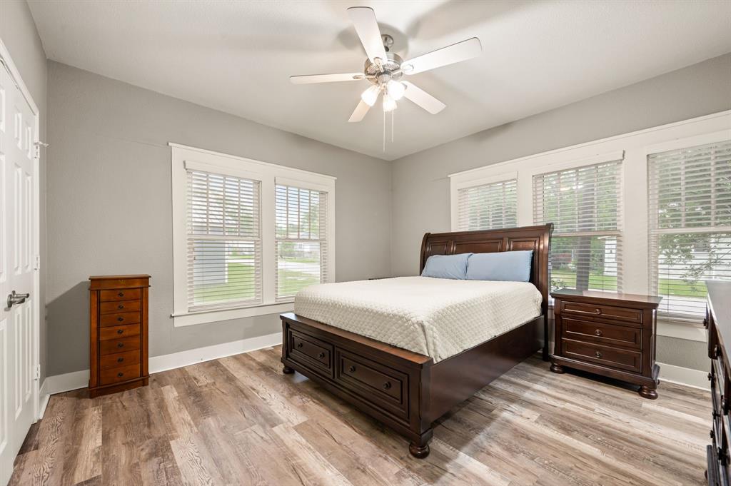 800 North Clements Street Gainesville, TX 76240 - Photo 15 of 27 a spacious bedroom with a bed and wooden floor