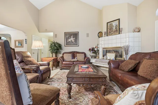 a living room with furniture and floor to ceiling windows
