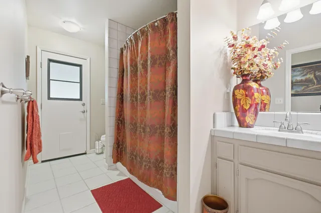 a bathroom with a double vanity sink and a mirror