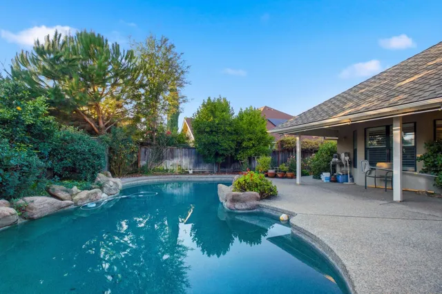 a view of a patio with table and chairs and potted plants