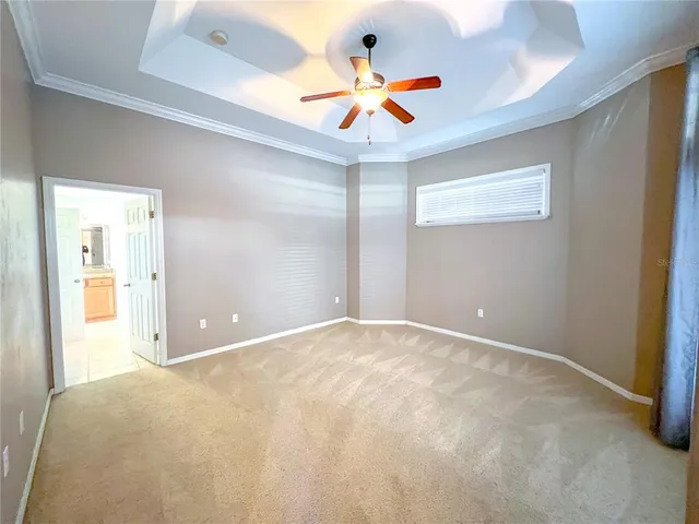a bathroom with a granite countertop tub sink and mirror