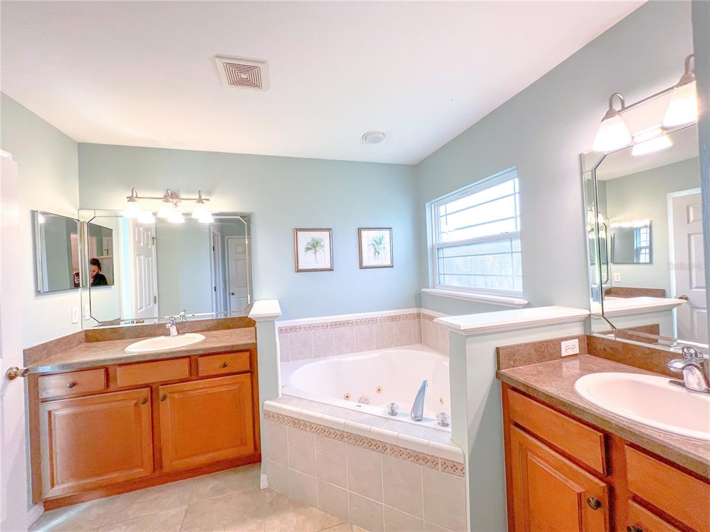 14479 Northwest 25th Road Newberry, FL 32669 - Photo 13 of 15 a bathroom with a granite countertop tub sink and mirror