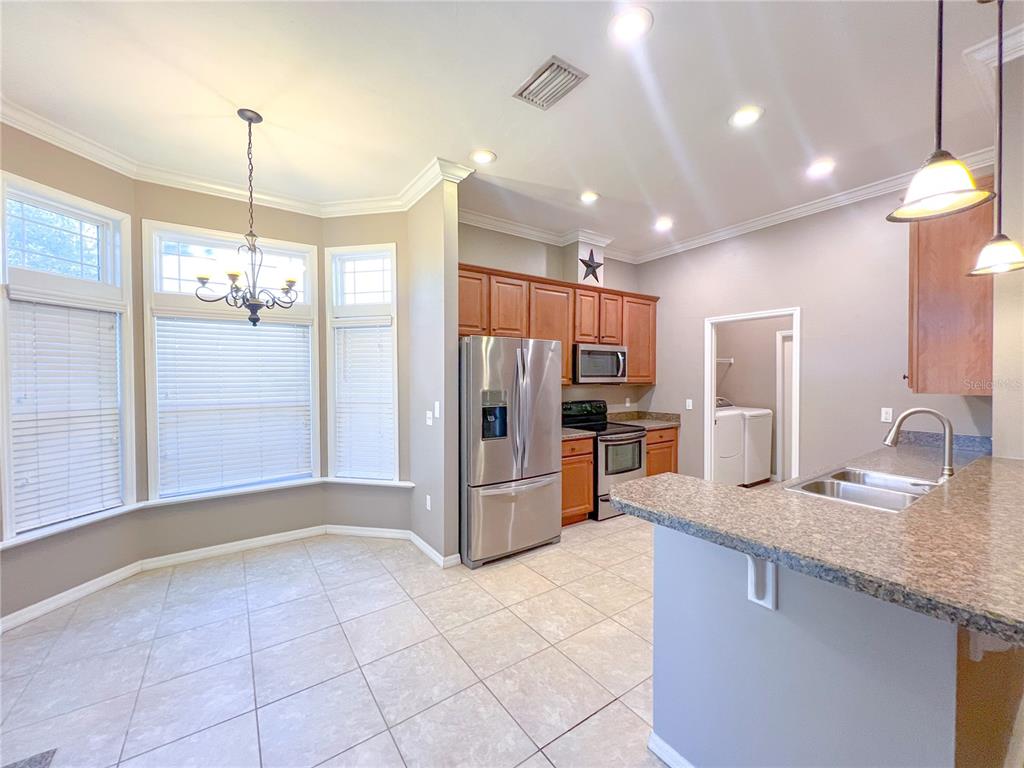 14479 Northwest 25th Road Newberry, FL 32669 - Photo 4 of 15 a kitchen with stainless steel appliances granite countertop a refrigerator and a sink