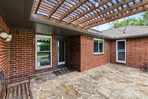 a view of backyard with a large tree