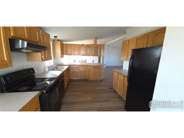 a kitchen with a refrigerator and a stove