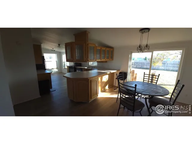 a view of empty room with window and wooden floor