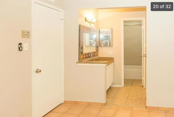 a bathroom with a sink a mirror and a shower