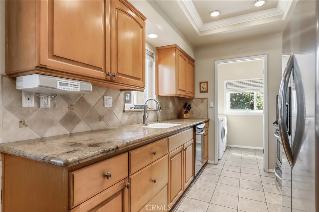 516 South Peregrine Street Anaheim, CA 92806 - Photo 14 of 34 a kitchen with stainless steel appliances granite countertop a sink stove and refrigerator