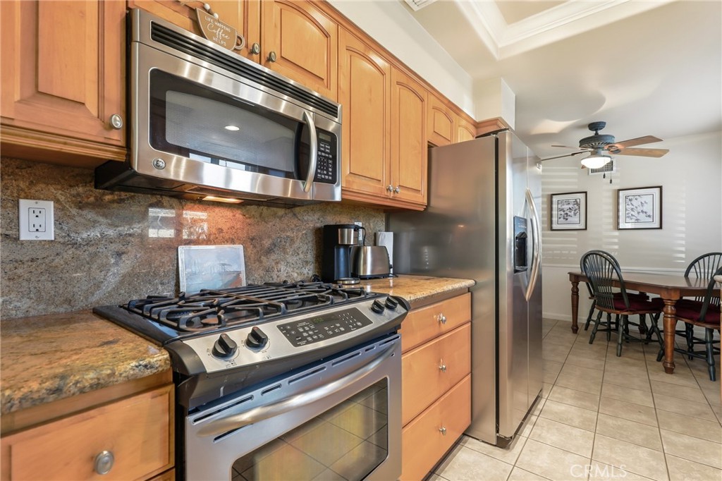 516 South Peregrine Street Anaheim, CA 92806 - Photo 15 of 34 a kitchen with stainless steel appliances granite countertop a stove and a microwave
