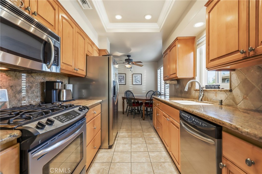 516 South Peregrine Street Anaheim, CA 92806 - Photo 17 of 34 a kitchen with stainless steel appliances granite countertop a stove and a sink