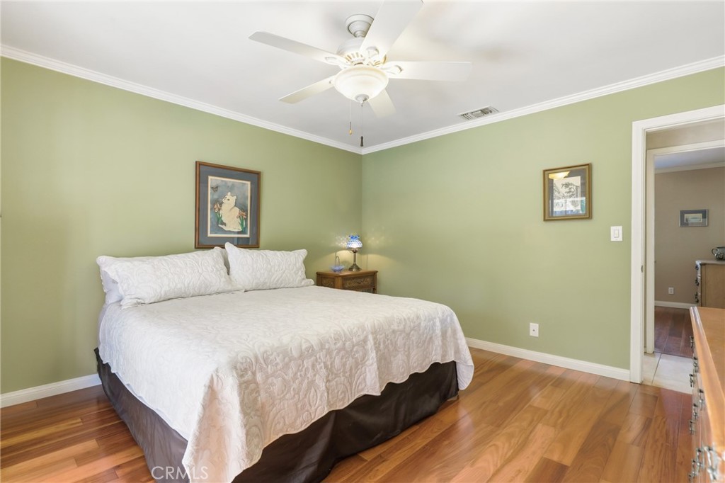 516 South Peregrine Street Anaheim, CA 92806 - Photo 20 of 34 a bedroom with a bed and a chandelier