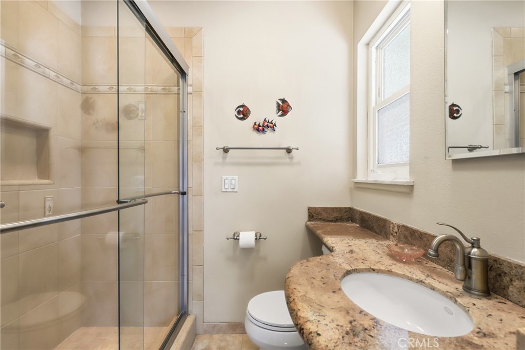 516 South Peregrine Street Anaheim, CA 92806 - Photo 25 of 34 a bathroom with a sink toilet and shower