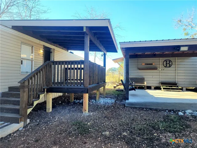 a view of a house with backyard and sitting area