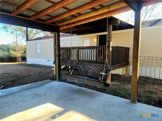a view of backyard with wooden fence