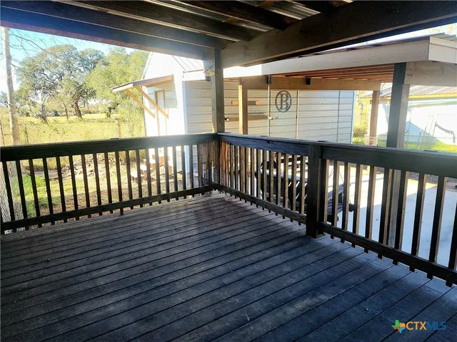 a view of a balcony with wooden floor